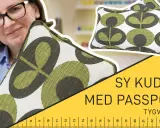 Kvinna med glasögon håller ett kuddfodral med grönt mönster. Texten "Sy kudde med passpoal!" syns.