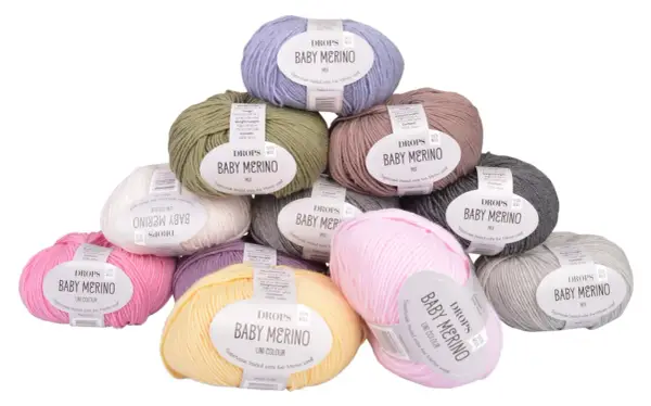 Här är ett urval av DROPS Baby Merino-garn i olika färger, perfekt för att sticka en mjuk babyfilt.